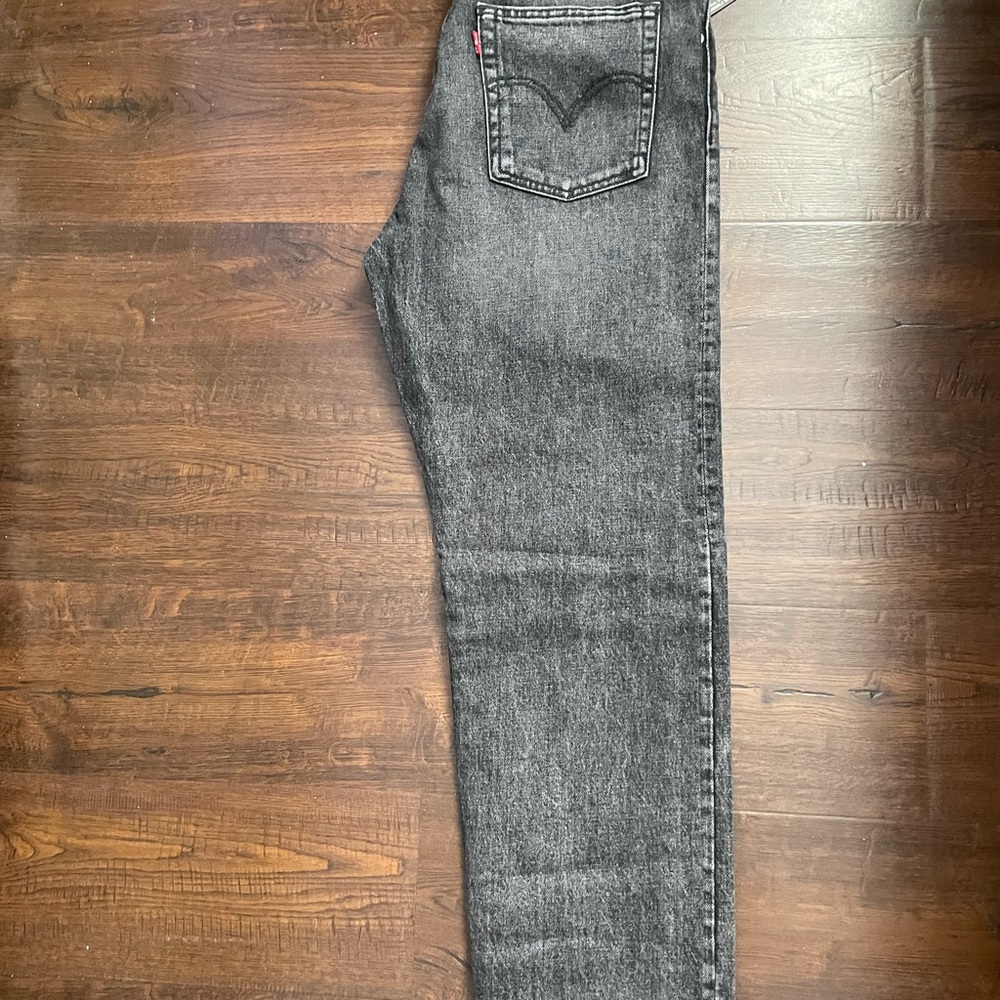 Black Levi Jeans. Size 28. High rise. Snug through hip and thigh. Tapered leg.